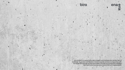Enaena biro logo on textured grey concrete surface with black scattered dots and definition of architect text
