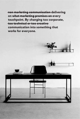Minimalist black and white office setup with modern desk, chair and shelving, featuring nmc branding text with strikethrough
