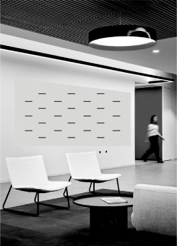 Modern office lobby with white minimalist chairs, geometric wall pattern, black metal ceiling grid, and blurred figure walkin