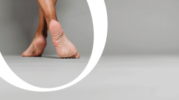 Minimalist logo design for domasi featuring bare feet walking through a white circular frame on gray background