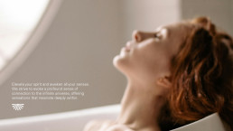 A woman with eyes closed and head tilted back in a peaceful, meditative pose, promoting Hello universe's spiritual wellness b