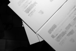 Open book with printed text pages in black and white, showing Viktor Žakelj's publication spread against dark background.