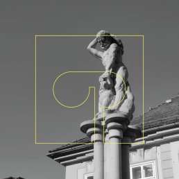 Logo design for Creative district Gornji trg overlaid on black and white statue photograph with yellow geometric outline elem